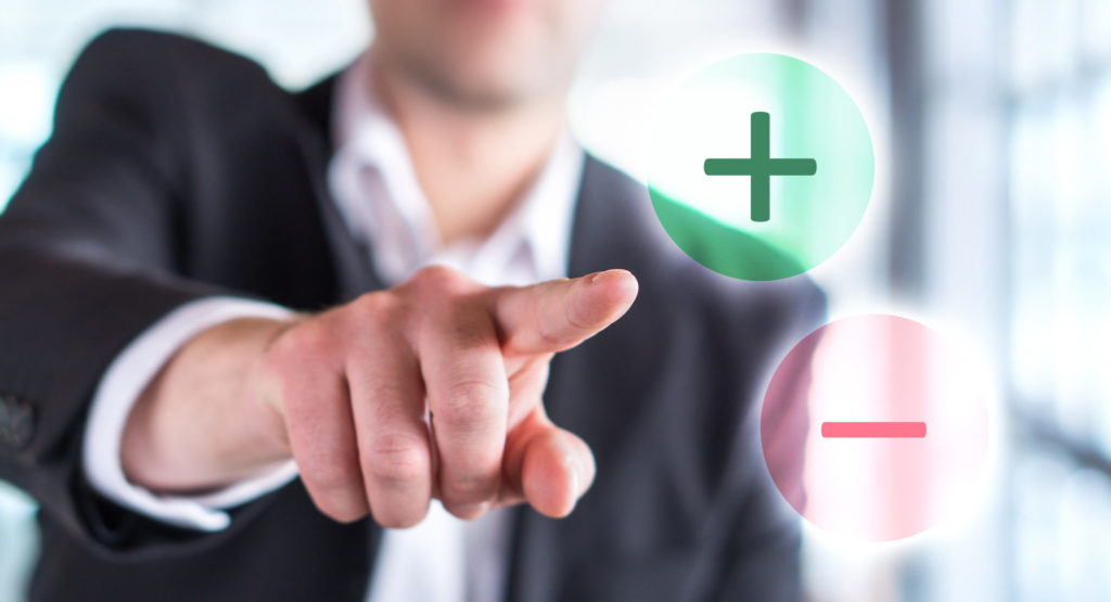 Pros and cons concept. Business man touching plus or minus symbol. Choosing between two options.