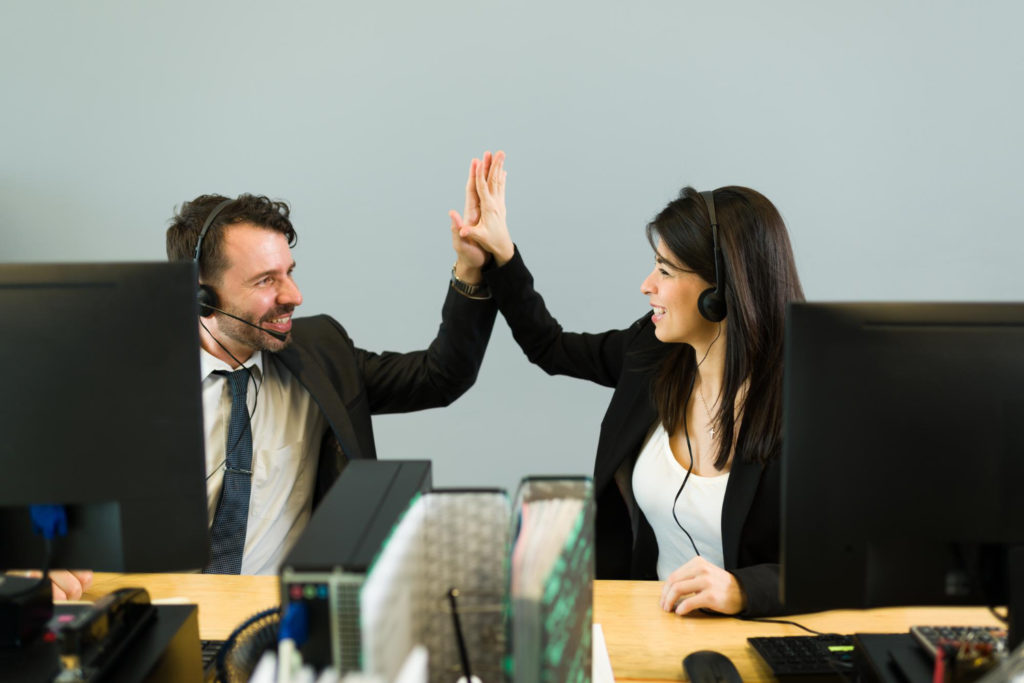 hispanic man young woman with headset doing high five while working together call center sales representative celebrating business sale