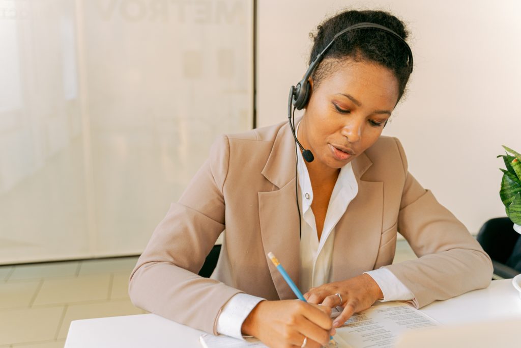 woman talking on the phone and writing