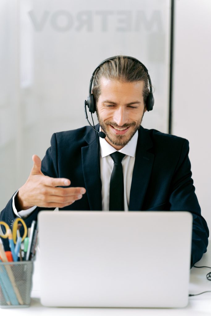 man talking on the phone and computer