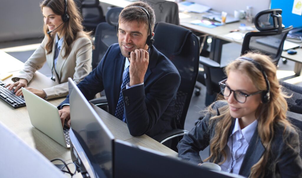 portrait call center worker accompanied by his team smiling customer support operator work min
